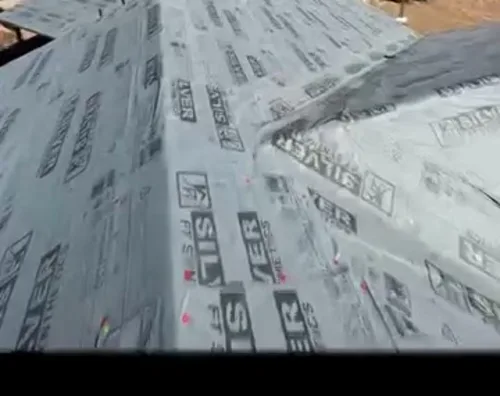 Synthetic underlayment installed across a hip roof